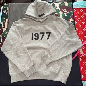Fear of God Essentials 1977 Heavyweight Hoodie - Dark Oat/Grey. SS22. BNIB